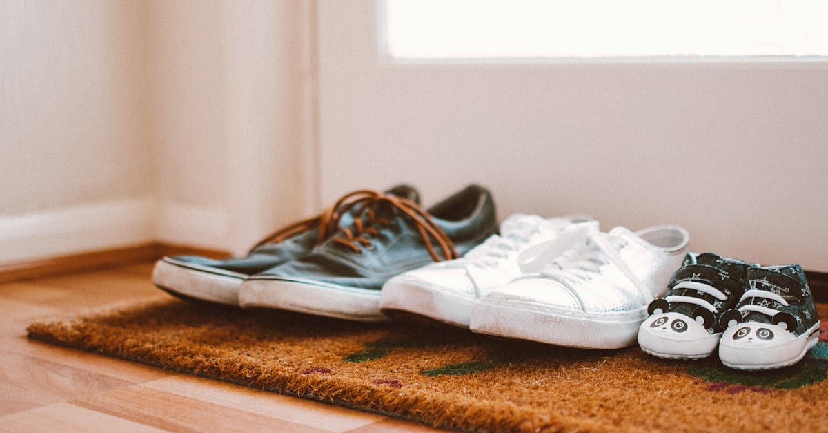 Cozy family shoes on a doormat at home entrance, symbolizing warmth and connection.